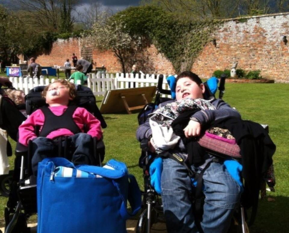 pair sat in chairs at event